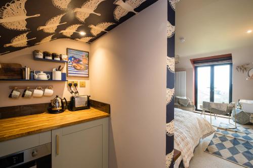 a room with a kitchen with a counter top and a room at Hanley House in Tenbury