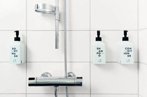 a bathroom with a sink and two soap bottles at Scandic Malmen in Stockholm