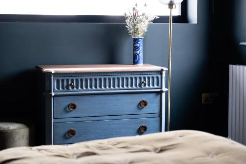 a blue dresser with a blue vase on top of it at Hanley House in Tenbury
