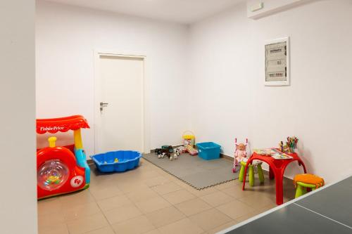 a room with a play room with toys on the floor at Nisos Villa, Pool & Heated SpaWhirlpool, Walking to Beach, By ThinkVilla in Sfakaki