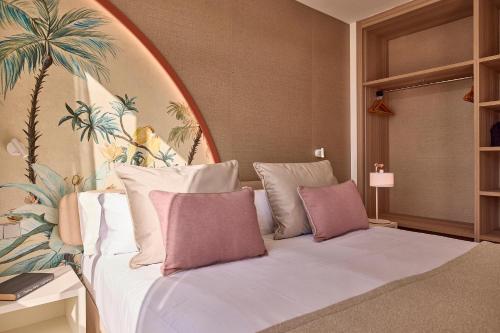 a bedroom with a white bed with pink pillows at Zafiro Alzinar Mar Adults Only - Refurbished 2025 in Can Picafort