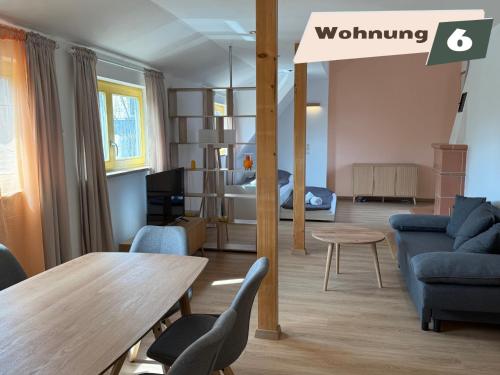 a living room with a couch and a table at Ferienwohnung Zum Böhmischen Bürgergarten in Radebeul