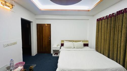 a hotel room with a bed and a window at Gulshan Palace 15 in Dhaka