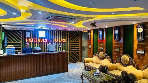 a hotel lobby with a reception desk and chairs at Gulshan Palace 15 in Dhaka