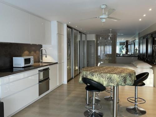 - une cuisine avec une table et un lit dans une chambre dans l'établissement STUDIO MAXXX - Héliopolis E85 Luxe 4 personnes, au Cap d'Agde