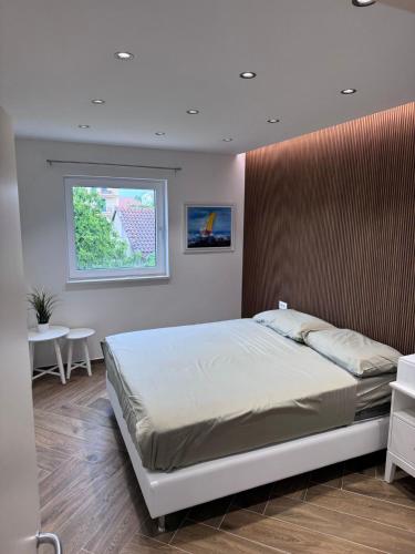 a bedroom with a bed and a window at Casa Trussardi in Pirovac