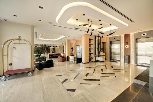 a living room with a lobby with a large tile floor at Coral Beach Hotel & Spa in Aqaba
