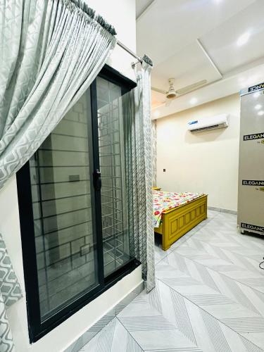 a room with a window and a bed at Premium Apartments in Gujrānwāla