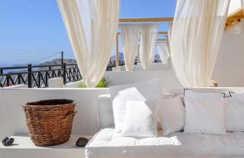 a white couch in a room with a window at IfestAu.4 Suites in Fira