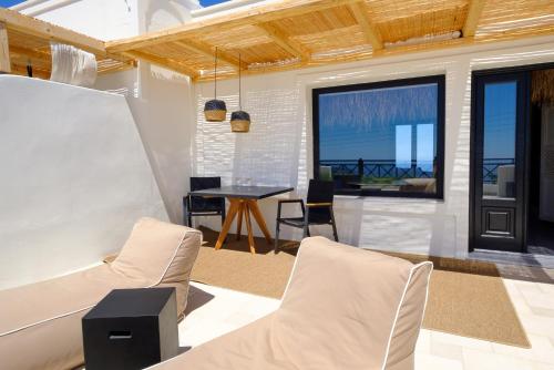 a living room with a table and chairs at IfestAu.4 Suites in Fira