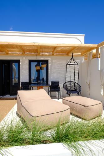 two beds sitting on the patio of a house at IfestAu.4 Suites in Fira