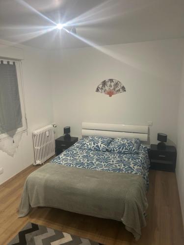 a bedroom with a bed in a white room at Appartement T2 in Dax