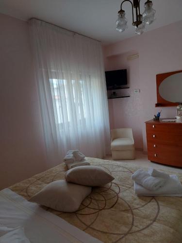 a bedroom with two pillows on a bed with a window at Rita's House in Bivona