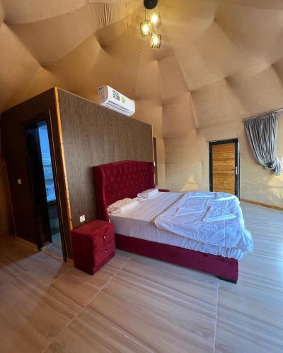 a bedroom with a bed in a room with a ceiling at Maha Wadi Rum in Wadi Rum