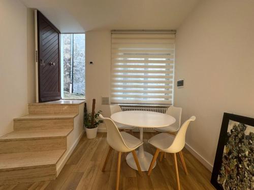 a dining room with a table and chairs and a window at Il nido della rondine in Ostra