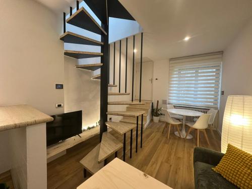 a living room with a staircase and a dining room at Il nido della rondine in Ostra
