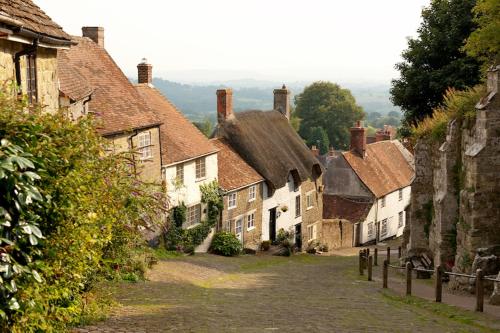 a group of old buildings in a village at Stylish 1-bed Cottage Escape in Piddlehinton in Piddlehinton