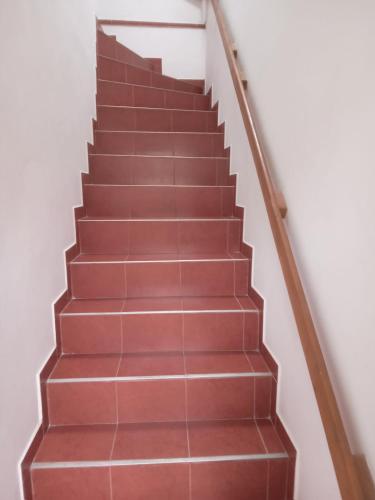 a set of stairs with red tile at First Floor Apartment 57A Fazekas utca in Tata
