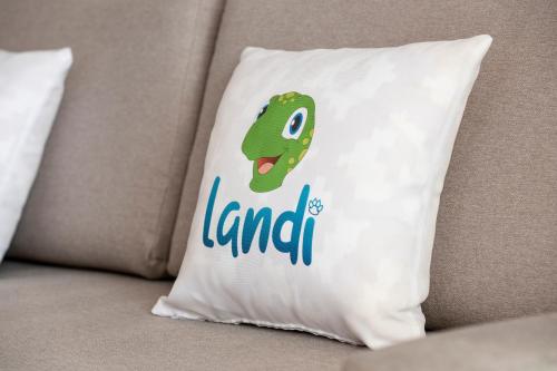 a pillow with a lizard on it on a couch at Landmar Costa los Gigantes Family Resort in Puerto de Santiago