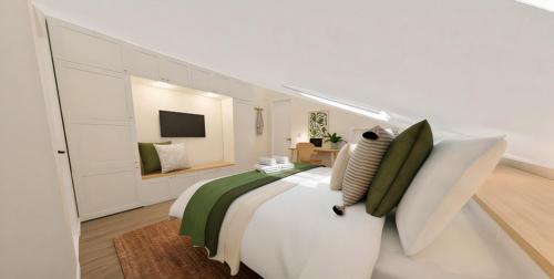 a bedroom with a large white bed with green pillows at Sítio 4 in Nazaré