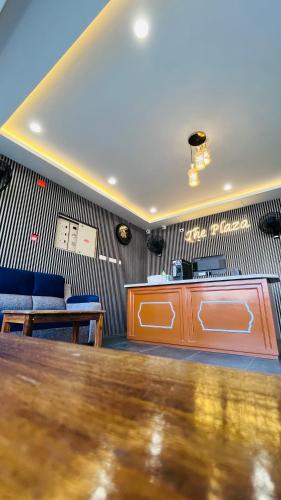 a waiting room with a table and blue chairs at THE PLAZA, Very Close to Indira Gandhi Square, Near Sri Kamatchi Hotel, 100 feet Road, PONDICHERRY - JR Groups in Puducherry