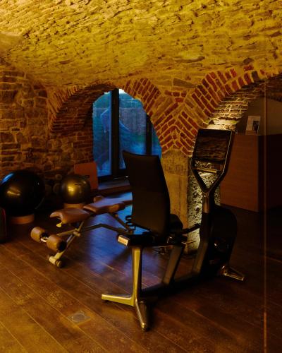 a room with a gym with a chair and weights at Ne5t Hotel & Spa in Namur