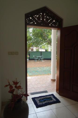 an open door to a patio with a potted plant at Neue Villa Wunderschön in Bentota