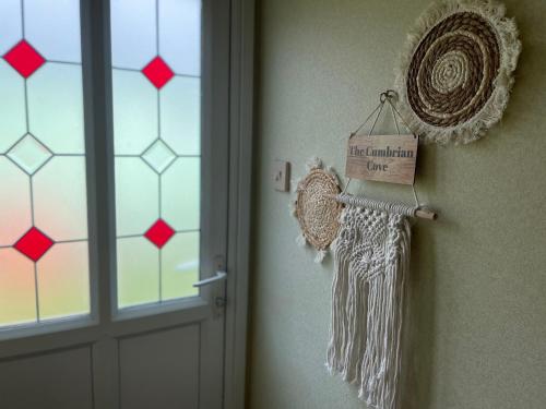 a door with a sign that reads last winter true at The Cumbrian Cove in Port Carlisle