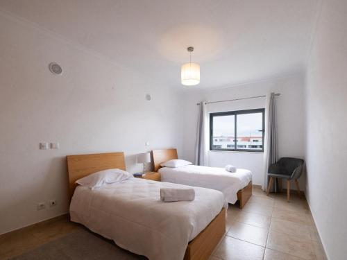 En eller flere senge i et værelse på Quinta das Palmeiras