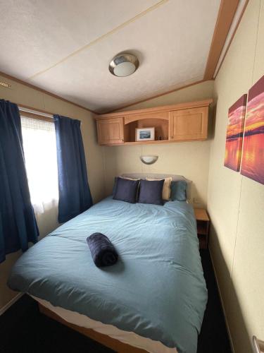 a bedroom with a bed with a cat laying on it at The Cumbrian Cove in Port Carlisle