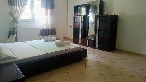 a bedroom with a bed and a dresser and a mirror at Lyra's house in Skiathos Town