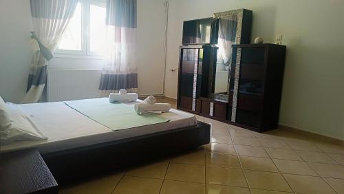 a bedroom with a bed and a dresser and a mirror at Lyra's house in Skiathos Town