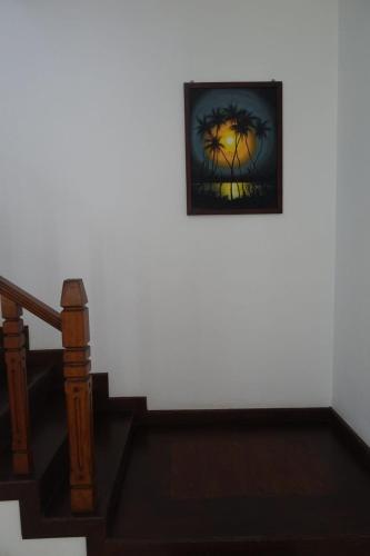 a picture of a palm tree on a wall at Neue Villa Wunderschön in Bentota