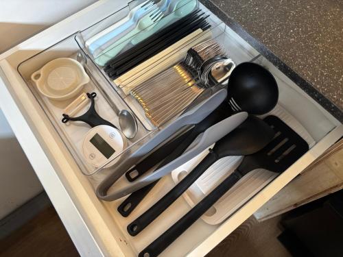 a drawer filled with cooking utensils on a counter at 簡易宿所 51ハウス 音と温泉 みんなで時間を楽しむ貸切一軒家 in Shiraoi