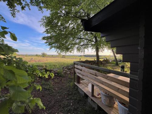 a view of a field from the porch of a house at Naturnära Fritidsboende, Trollebo - YinTorp in Arkelstorp