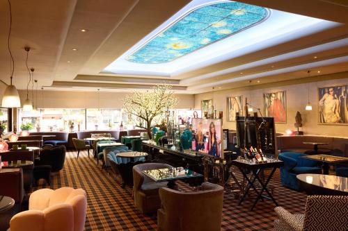 a restaurant with a ceiling with a stained glass window at President Hotel Athens in Athens