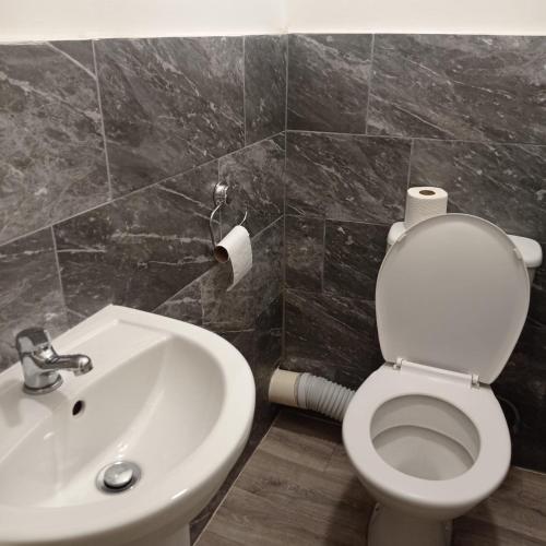 a bathroom with a white toilet and a sink at Double-Bedroom in the Heart of Salford Manchester Perfect for Short Stays LT2 in Manchester