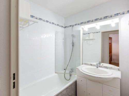 une salle de bain blanche avec un lavabo et une douche dans l'établissement Charmant Duplex 7 Pers. avec Terrasse Sud, Piscine, et Fitness à La Mongie - FR-1-404-294, à Bagnères-de-Bigorre