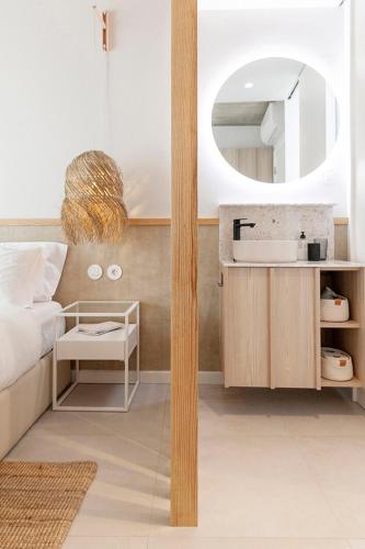 a bedroom with a sink and a mirror at Wood Beach in Monte Gordo