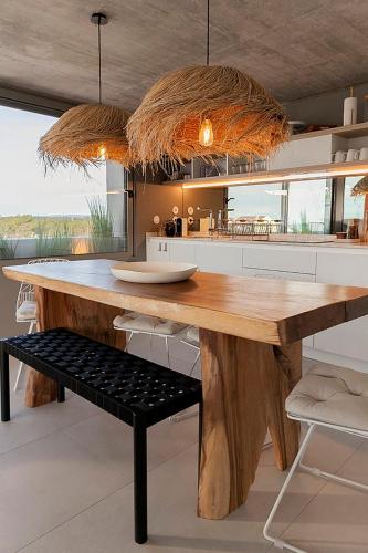 a kitchen with a large wooden table with a bench at Wood Beach in Monte Gordo