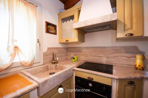 a kitchen with a sink and a stove at La Dimora dell'Artista in Manerba del Garda