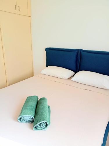 two green towels are sitting on a bed at Sal Rei apartaments, Boa Vista, free WI-FI in Sal Rei