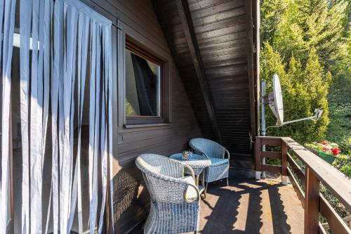 a porch with two chairs and a window at Haus Waldesruh in Medebach