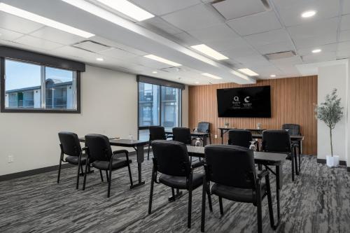 a conference room with tables and chairs and a tv at Quality Inn & Conference Centre Kingston Central in Kingston