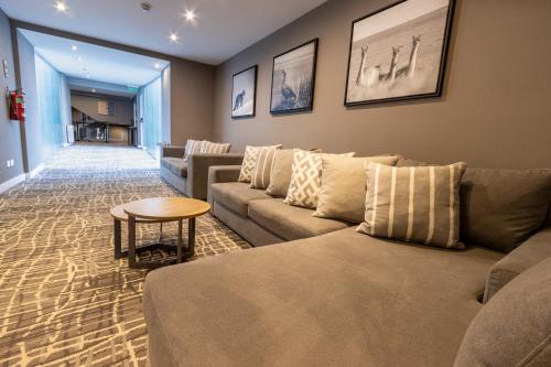 a living room with a couch and a table at Alto Andino Hotel in Ushuaia