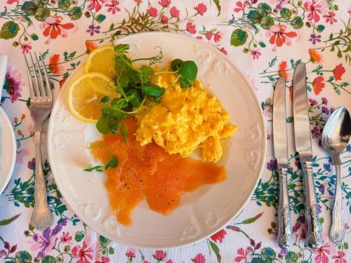 a plate of food with eggs and greens on a table at The Robin Hill in Torquay
