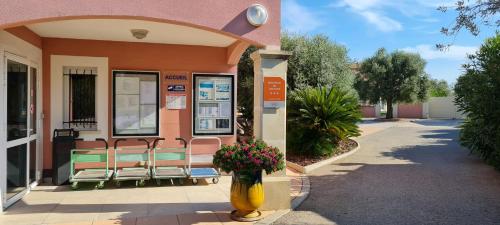 a vase of flowers in front of a building at Appart'hotel Résidence La Provence in Istres