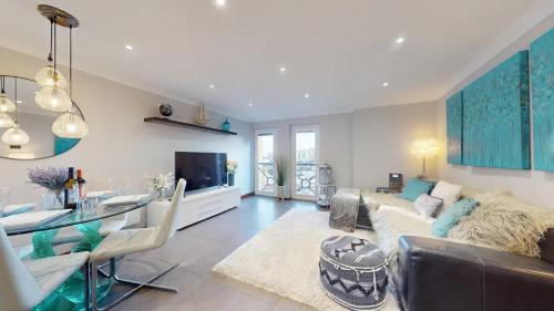 a living room with a couch and a table at Marina View Apartment in Swansea