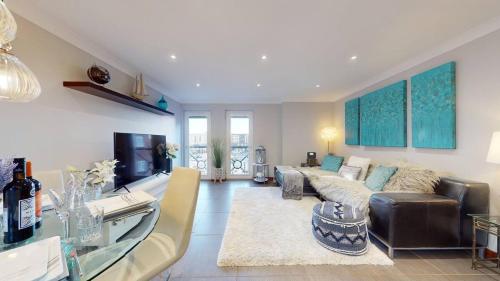 a living room with a couch and a table at Marina View Apartment in Swansea