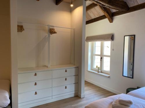 a bedroom with a shower and a white dresser at Landgoed De Hoogmolen in Oudsbergen 